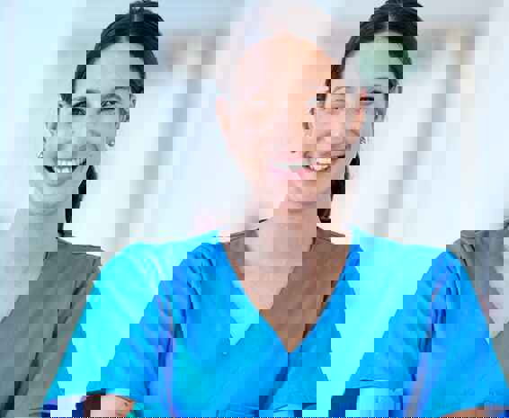 A healthcare worker smiling after successfully securing a disability care role